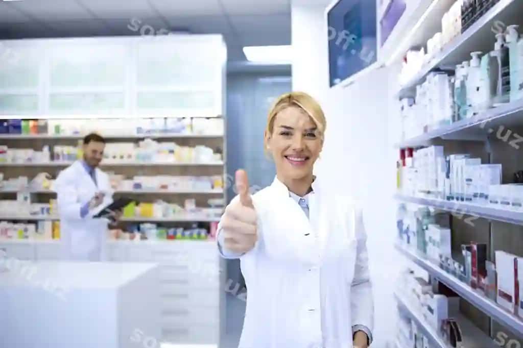 Portret go'zal qizil sochli ayol farmatsevt boshini ko'tarib apteka do'koni | Portrait beautiful female blonde pharmacist holding thumbs up pharmacy shop drugstore