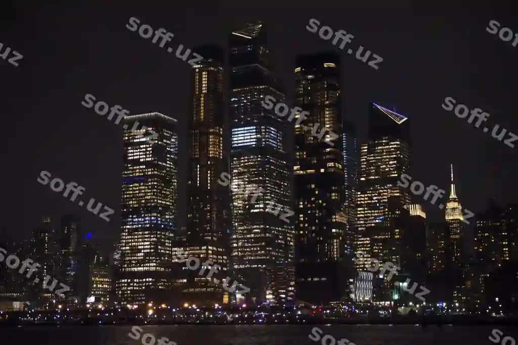 Yorqin binolar tundagi osmon orqali | Illuminated buildings against sky night