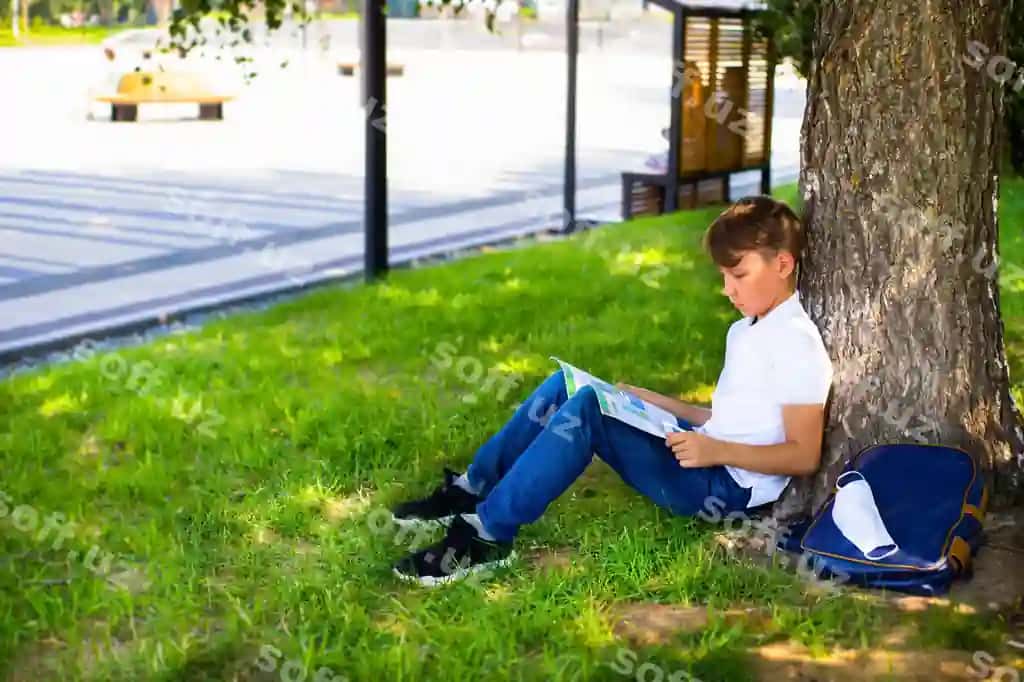 Talaba o'g'li parkda Covid-19 panetmasi davomida uy vazifasini bajarayotgan. | Student boy is doing homework park covid 19 pandemic